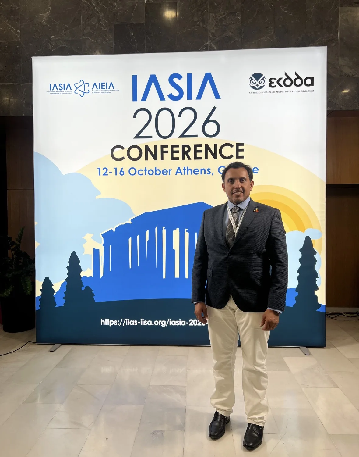 An Arabian Gulf University graduate presents a model for artificial intelligence governance at the IASIA 2026 conference in Athens